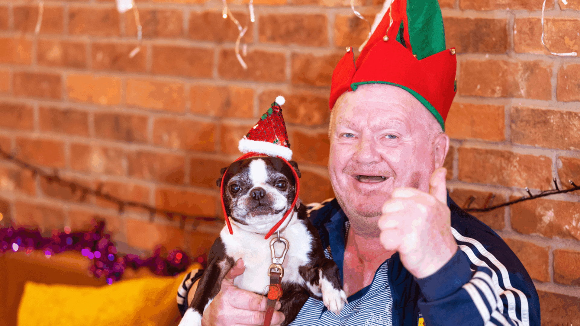 Jim and his dog Minnie in Christmas hats