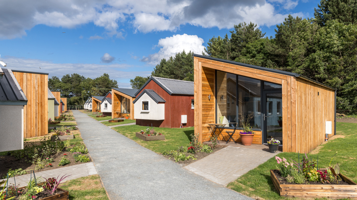 View down the path at the Social Bite Village in Edinburgh with nest houses either side of the path. 