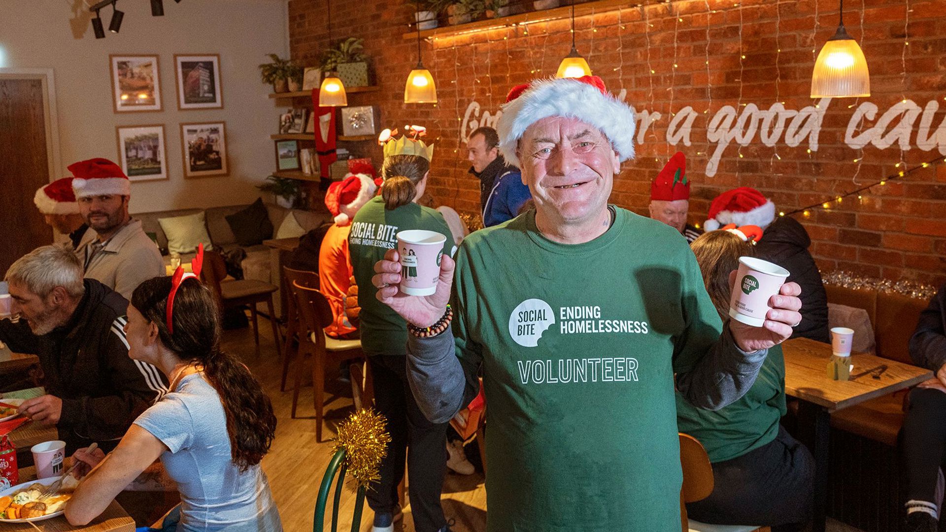 Social Bite volunteer holding cups at Christmas lunch