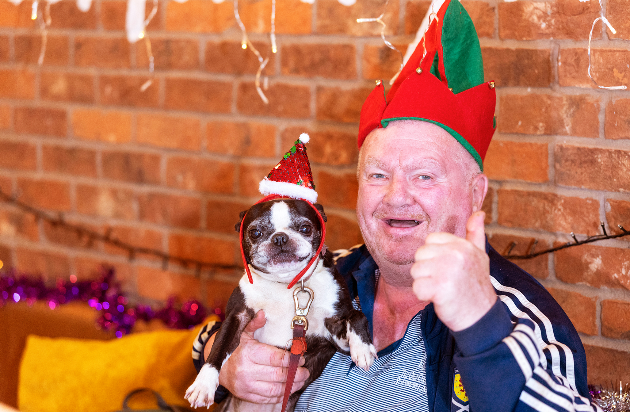 Jim and his dog Minnie in Christmas hats