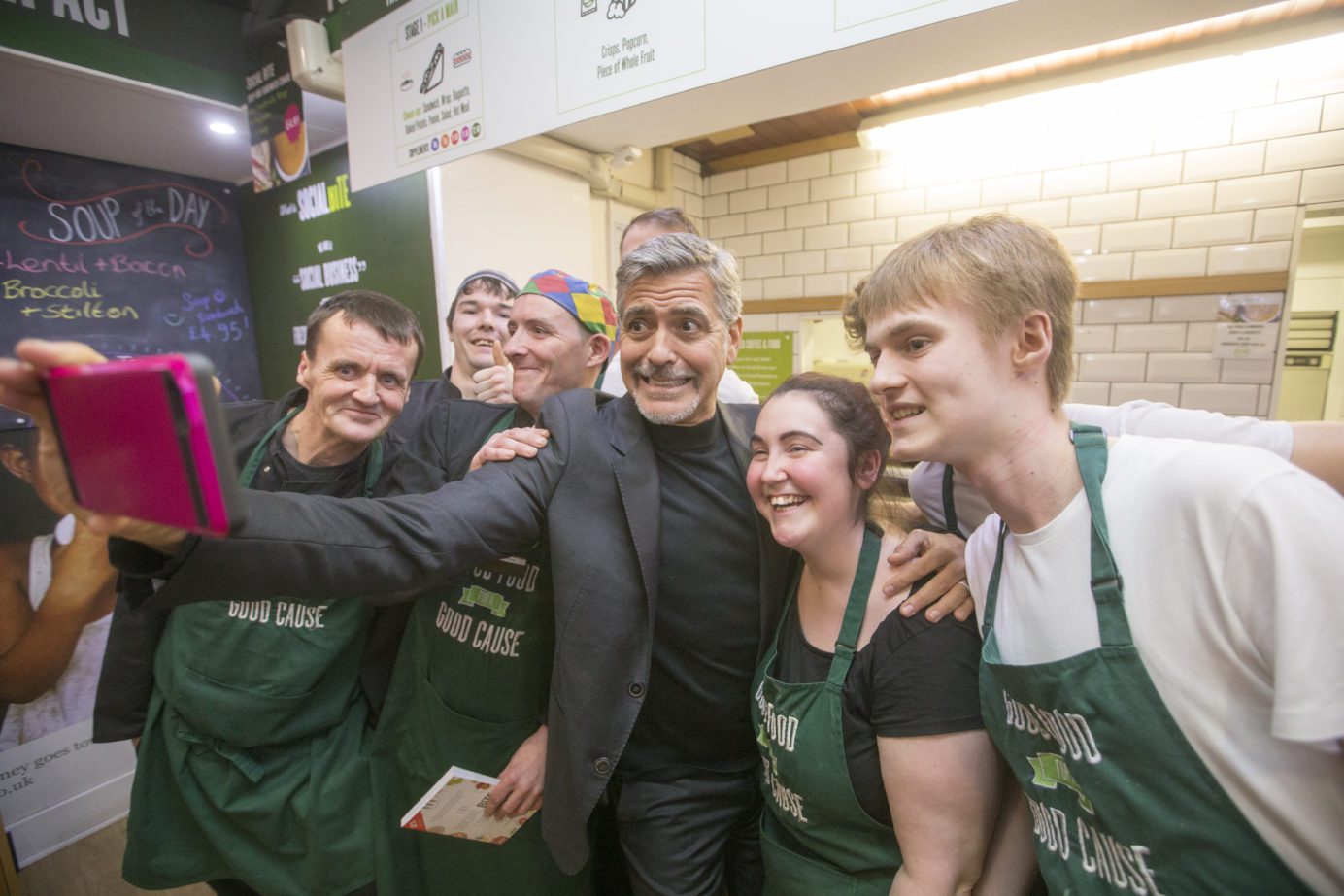 George Clooney takes a selfie with four staff at Social Bite